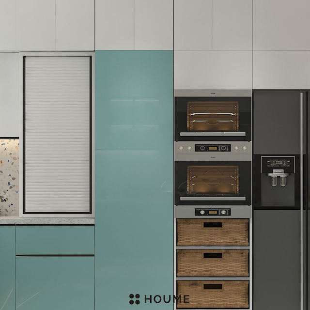 Modern kitchen with open wood shelves, warm stained butcher block breakfast bar with black metal legs and stools, stainless steel sink with a gooseneck faucet, and a window with a black frame overlooking a green backyard. Text overlay: Houme India - Kitchen Design Ideas. B