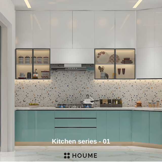 Modern kitchen with open wood shelves, warm stained butcher block breakfast bar with black metal legs and stools, stainless steel sink with a gooseneck faucet, and a window with a black frame overlooking a green backyard. Text overlay: Houme India - Kitchen Design Ideas.