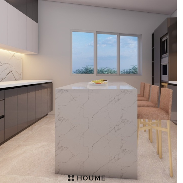 Modern kitchen with black stainless steel stovetop, oven, and vent hood, light wood cabinets, and a white quartz countertop. A ceiling fan with woven blades hangs from the ceiling. Text overlay: Houme India - Kitchen Design Ideas. E