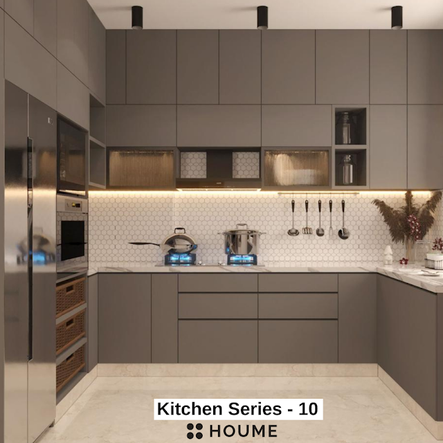 Modern kitchen with open wood shelves, butcher block breakfast bar with black metal legs and stools, stainless steel sink, and a window with a black frame overlooking a green backyard. Text overlay: Houme India - Kitchen Design Ideas.