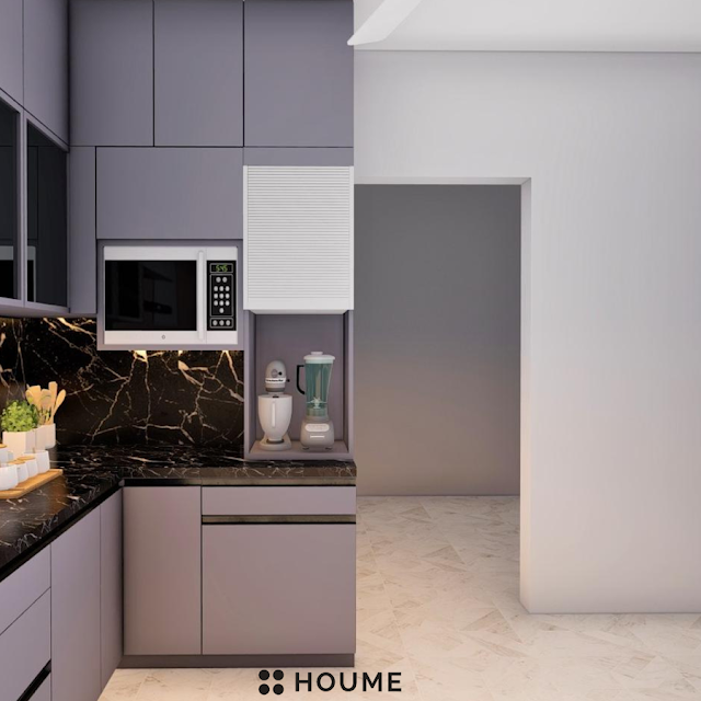 Luxurious kitchen featuring a large white marble island with waterfall edges, brass fixtures, and dark wood cabinetry. Text overlay: Houme India - Kitchen Design Ideas.B