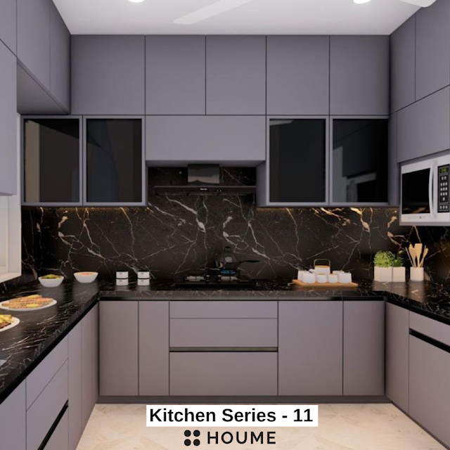 Luxurious kitchen featuring a large white marble island with waterfall edges, brass fixtures, and dark wood cabinetry. Text overlay: Houme India - Kitchen Design Ideas.