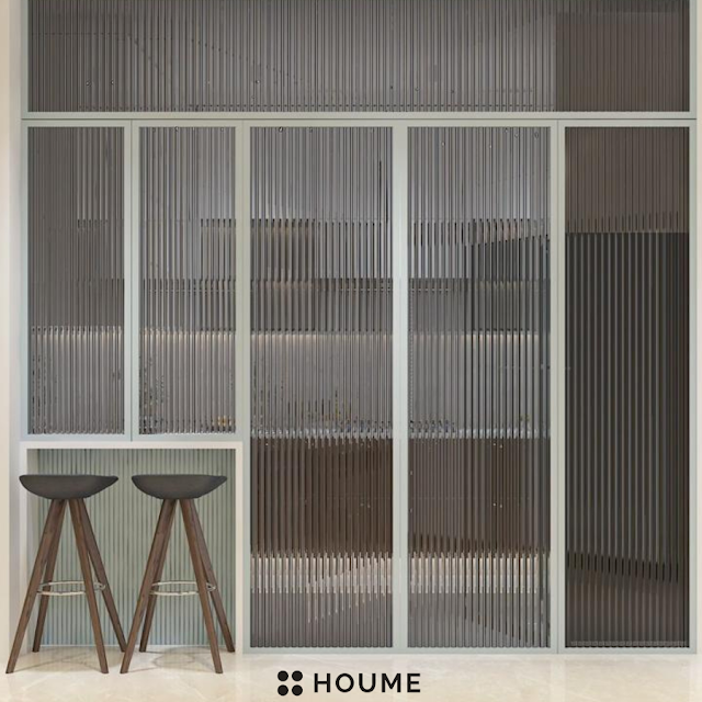 Traditional Indian kitchen with patterned tile flooring, wooden cabinets in a warm brown tone, and a vintage ceiling fan with woven blades. Text overlay: Houme India - Kitchen Design Ideas. D
