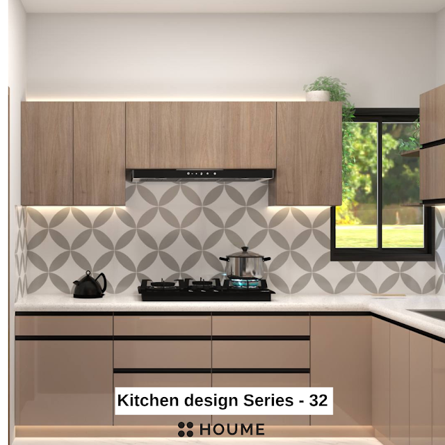 Kitchen with a stainless steel stove and a black pot on the burner. A window with a black metal frame is above the stove, and a white patterned tile backsplash can be seen behind the stove. Text overlay: Houme India - Kitchen Design Ideas.