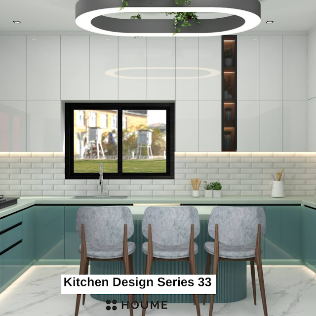 Kitchen with a stainless steel stove and a black pot simmering on the burner. A window with a black metal frame is above the stove, revealing a green backyard. A white patterned tile backsplash adds a decorative touch behind the stove. Text overlay: Houme India - Kitchen Design Ideas.