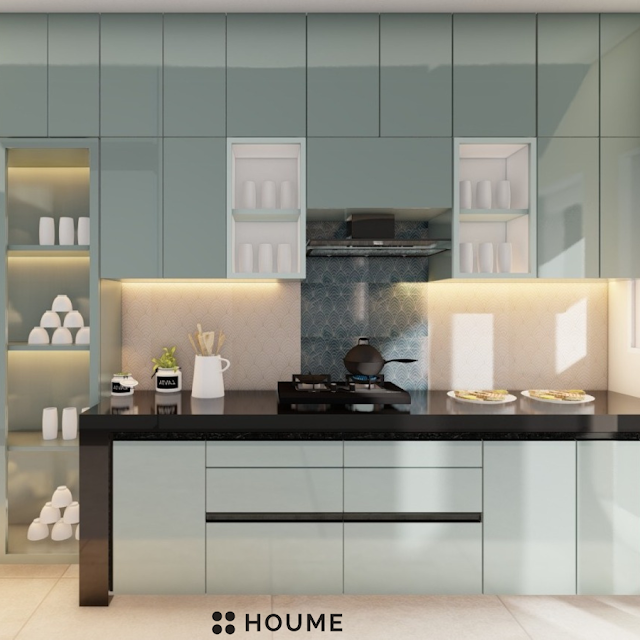 Modern kitchen with white shaker cabinets, black quartz countertops, a geometric tile backsplash in black and white, and a gold faucet. Text overlay: Houme India - Kitchen Design Ideas.B