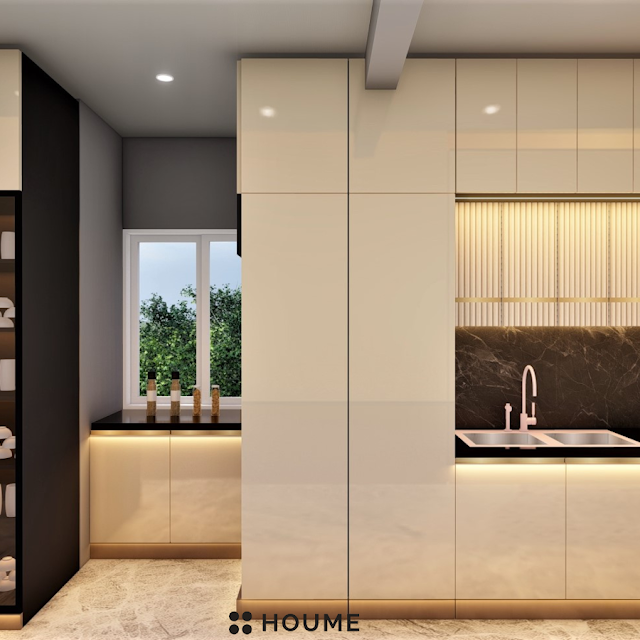 Modern kitchen with open wood shelves, warm stained butcher block breakfast bar with black metal legs and stools, stainless steel sink, and a window with a black frame overlooking a green backyard. Text overlay: Houme India - Kitchen Design Ideas.B