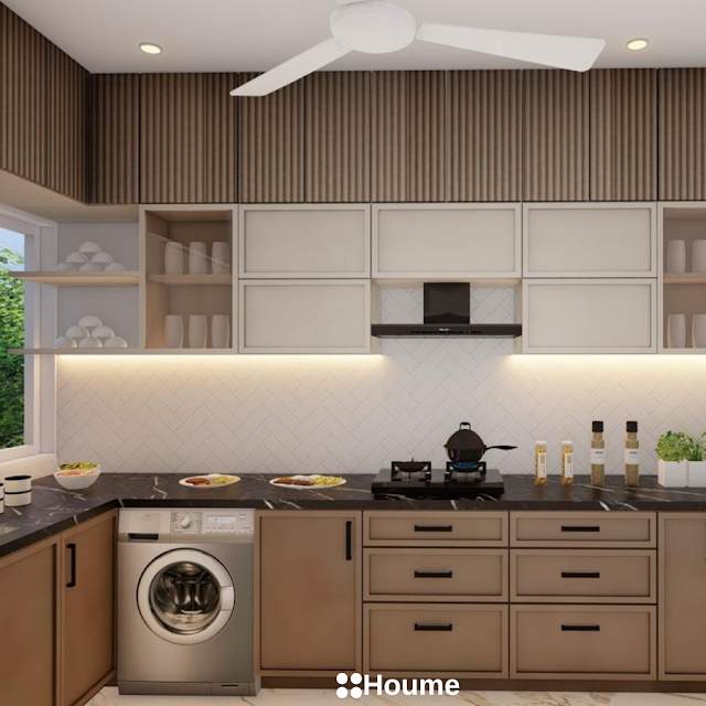 Modern kitchen with white quartz countertops, a black herringbone patterned backsplash, a black sink with a gooseneck faucet, and white cabinets with chrome hardware. Text overlay: Houme India - Kitchen Design Ideas. C
