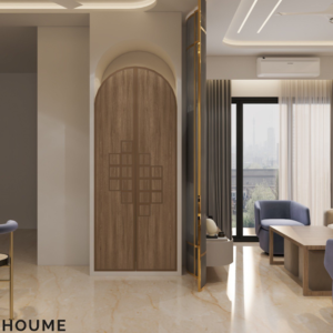 Living room featuring a large leaning mirror with a brushed gold metal frame, a round jute rug in a light natural color, and a white boucle armchair with a curved wooden frame. Text overlay: Houme India - Interior Design Ideas. D