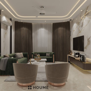 Living room with a green velvet sofa, a round brass coffee table with a marble top, and a woven jute rug. Text overlay: Houme India - Interior Design Ideas. C