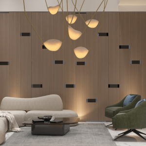 Living room with a modern gray couch, round wood coffee table with black metal legs, and a woven jute rug. Text overlay: Houme India - Interior Design Ideas. B
