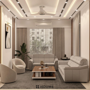 Mid-century modern living room featuring an olive green fabric sofa with button tufting and tapered wooden legs. A round wood coffee table with splayed legs sits on a cream colored area rug. Text overlay: Houme India - Interior Design Ideas. B
