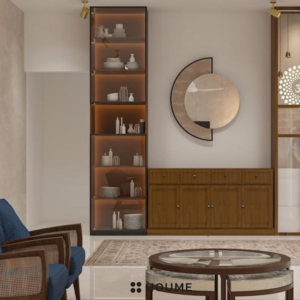 Living room with a ceiling fan with woven blades hanging from the ceiling. A brown leather couch sits on a woven jute rug. Two brown accent chairs flank a round wooden coffee table. Text overlay: Houme India - Interior Design Ideas. C