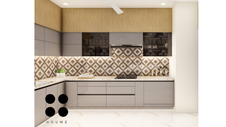 Modern kitchen interior featuring white cabinets with chrome hardware and white quartz countertops. A stainless steel sink and faucet are visible in the foreground, with a built-in oven and microwave stacked in a tall cabinet to the left and a built-in dishwasher beneath the counter to the right. Text overlay: Houme India - Interior Design Ideas. B