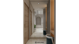 Walk-in closet interior featuring a long vanity with a white countertop and a rectangular mirror with a chrome frame above the countertop. Wood shelves line the walls on either side of the vanity, and drawers with chrome knobs are installed below the shelves on one side. Text overlay: Houme India - Interior Design Ideas. B
