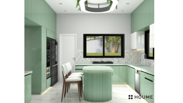 Kitchen interior featuring green cabinets with chrome hardware and black countertops. A black refrigerator and oven are visible in the background. Text overlay: Houme India - Interior Design Ideas.B