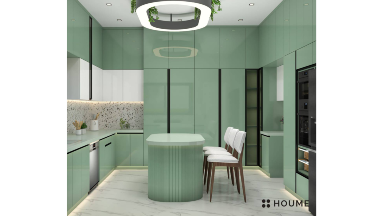 Kitchen interior featuring green cabinets with chrome hardware and black countertops. A black refrigerator and oven are visible in the background. Text overlay: Houme India - Interior Design Ideas. C