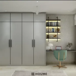 Simple, clean bathroom interior in a 3D rendering. The bathroom features a white toilet, pedestal sink with a chrome faucet, and a rectangular mirror with a chrome frame above the sink. The walls are a light beige color, and a window with frosted glass on the right wall allows for natural light. Text overlay: Houme India - Interior Design Ideas. D