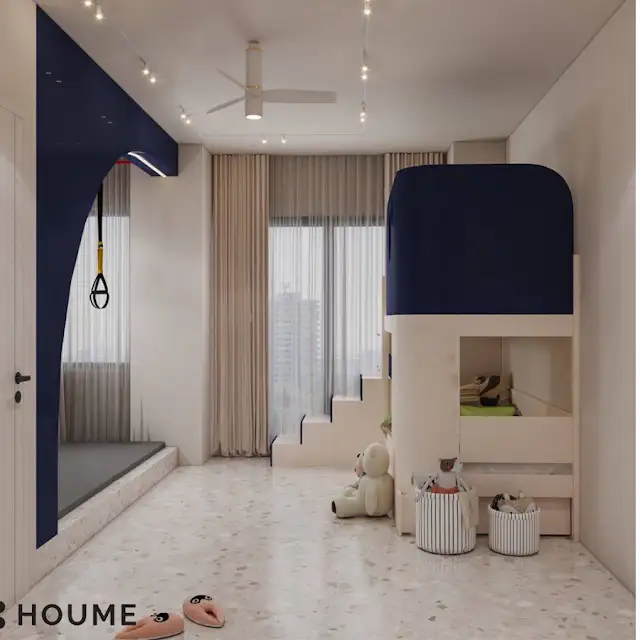 Children's bedroom interior featuring a climbing wall with colorful handholds in various shapes and sizes. The climbing wall covers one wall of the bedroom. Text overlay: Houme India - Interior Design Ideas. C