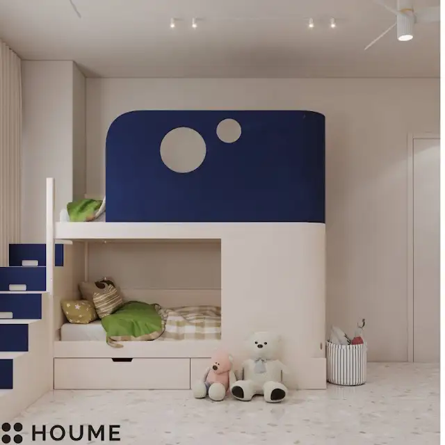Children's bedroom interior featuring a climbing wall with colorful handholds in various shapes and sizes. The climbing wall covers one wall of the bedroom. Text overlay: Houme India - Interior Design Ideas. D