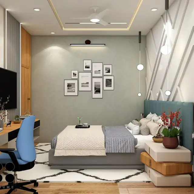 Bedroom interior featuring a wooden platform bed with a white quilt and pillows. A wooden nightstand with a woven basket sits beside the bed. A table lamp with a white shade sits on the nightstand. A woven rug in a light natural color is on the floor. Text overlay: Houme India - Interior Design Ideas. B