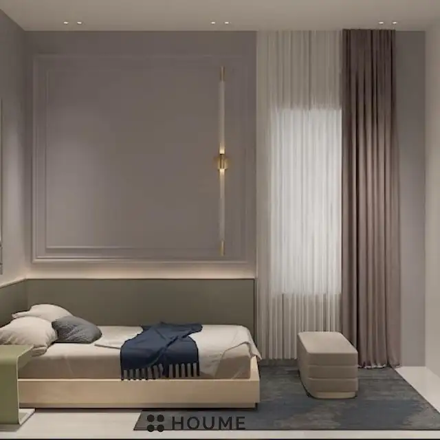 Bedroom featuring a mid-century modern platform bed with a walnut wood frame and a woven cream blanket. A round wooden nightstand with a drawer sits beside the bed. A woven jute rug in a light natural color covers the floor. Text overlay: Houme India - Interior Design Ideas. C