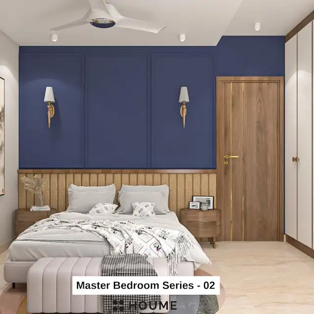 Mid-century modern bedroom interior featuring a platform bed with a walnut wood frame and a woven cream blanket and pillows. A round wooden nightstand with a drawer sits beside the bed. A woven jute rug in a light natural color covers the floor. The wall behind the bed is painted a light blue color. Text overlay: Houme India - Interior Design Ideas.