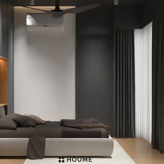 Mid-century modern master bedroom interior featuring a low profile platform bed in walnut wood with a woven cream blanket and pillows. A round wooden nightstand with a drawer sits beside the bed. A woven jute rug in a light natural color covers the floor. A ceiling fan with woven blades hangs from the ceiling. Text overlay: Houme India - Interior Design Ideas. C