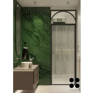 Modern bathroom interior featuring a freestanding bathtub positioned in the center of the room, with a large window behind it offering a view of a garden. The bathtub has a chrome faucet and sits on a white tile floor. Text overlay: Houme India - Interior Design Ideas. C