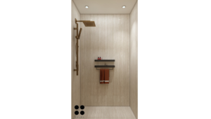 A close-up photo of a modern kitchen faucet with a brushed gold finish and a single, curved handle. The faucet is mounted on a white farmhouse sink with a soap dispenser in a matching brushed gold finish. C