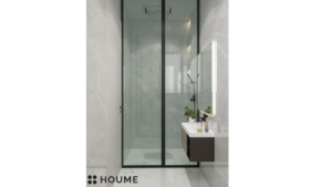 A modern washroom design with gray marble walls, a floating wood vanity with a black countertop, recessed shelves with integrated lighting, and a frameless glass shower enclosure. C