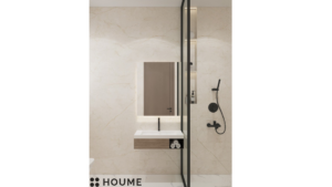 A modern washroom design with neutral toned tiles, a black framed glass shower enclosure, a floating black vanity, and recessed shelving. C