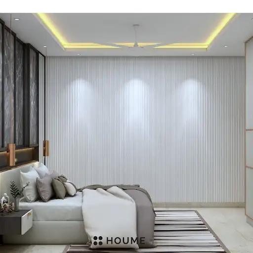 A modern and elegant parents' bedroom with a marble accent wall, a sleek platform bed, and warm accent lighting. B