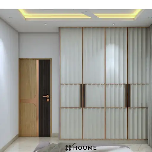 A modern and elegant parents' bedroom with a marble accent wall, a sleek platform bed, and warm accent lighting. D