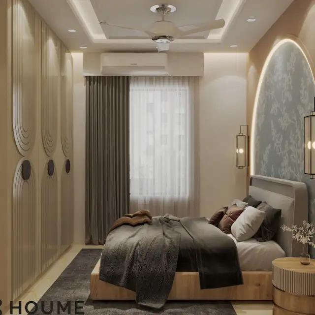 A modern bedroom with a gray upholstered bed, a floral patterned headboard, and warm accent lighting B