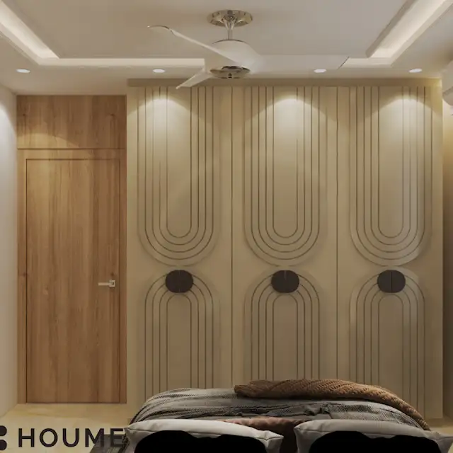 A modern bedroom with a gray upholstered bed, a floral patterned headboard, and warm accent lighting D