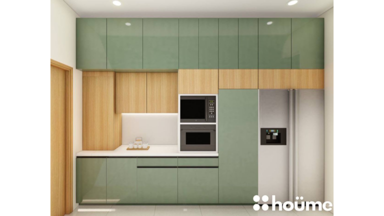 A modern L-shaped kitchen with light wood upper cabinets, sage green lower cabinets, and a breakfast bar. B