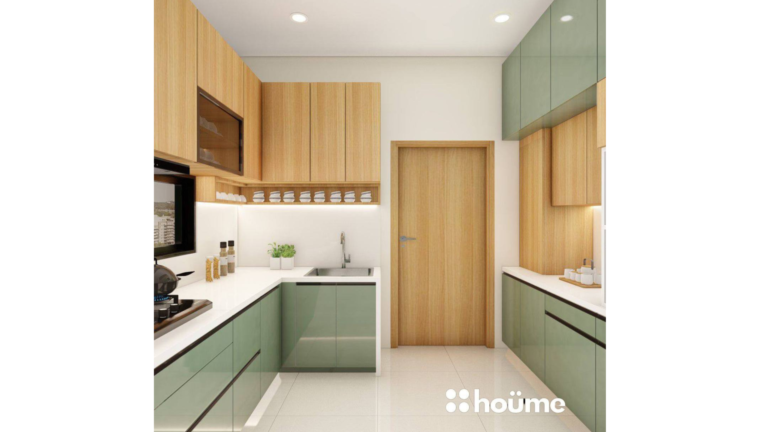 A modern L-shaped kitchen with light wood upper cabinets, sage green lower cabinets, and a breakfast bar. C