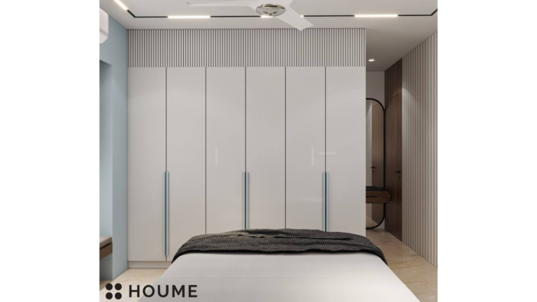 A modern master bedroom with a blue headboard, featuring artwork of cranes on the wall behind the bed D