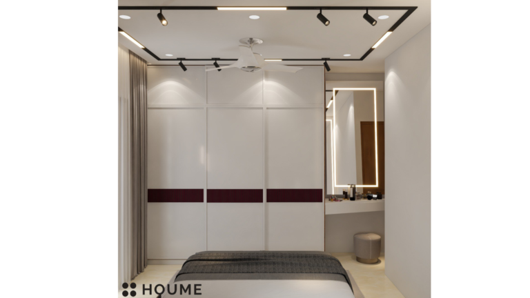 A modern master bedroom with a deep red headboard, pendant lights, and a mirrored accent wall. C
