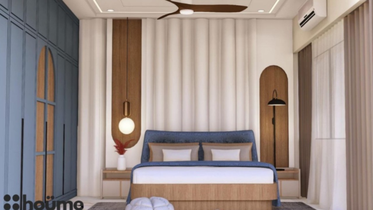 A digitally rendered image of a master bedroom interior featuring a blue upholstered bed, a blue wardrobe, wood-paneled accent walls, and modern pendant lights. B