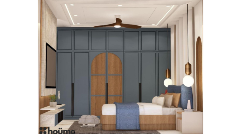A digitally rendered image of a master bedroom interior featuring a blue upholstered bed, a blue wardrobe, wood-paneled accent walls, and modern pendant lights. C