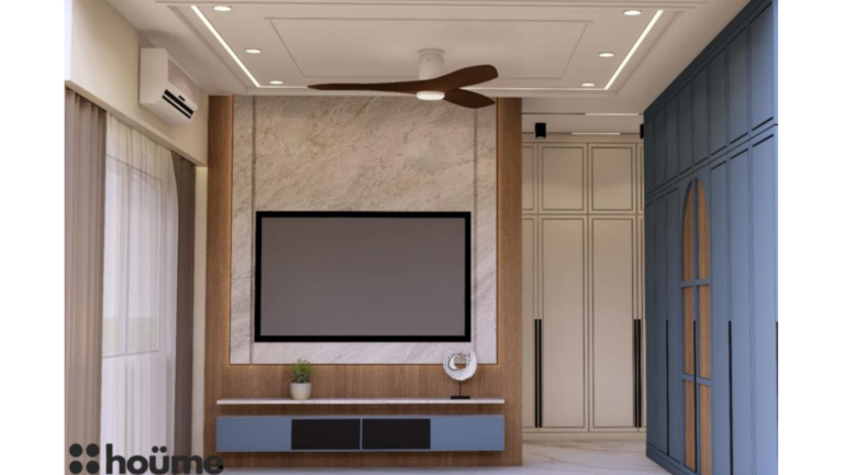 A digitally rendered image of a master bedroom interior featuring a blue upholstered bed, a blue wardrobe, wood-paneled accent walls, and modern pendant lights. E