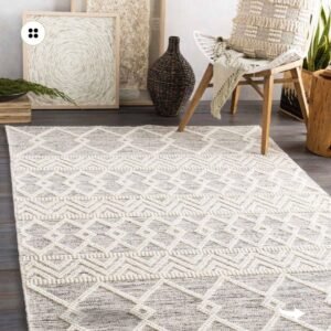 A white and grey area rug with a diamond pattern adds a touch of minimalist style to a living room.