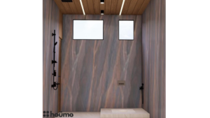 A modern washroom design by Houme India with a gray textured accent wall, black bathroom fixtures, and a wooden ceiling with recessed lighting. B