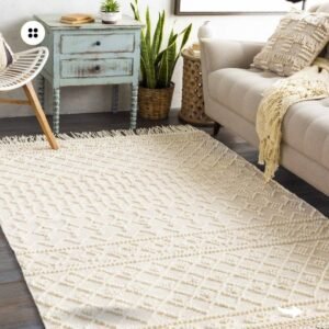 A beige woven rug with a diamond pattern adds warmth to a minimalist living room.