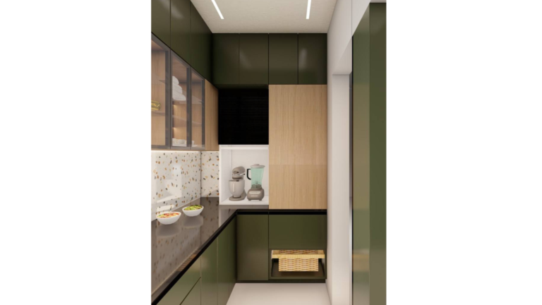 A contemporary L-shaped kitchen with dark green cabinets, wood upper cabinets with glass doors, and a speckled backsplash. The countertop is a dark material, and various dishes are placed on it. B