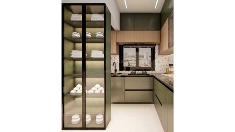 A contemporary L-shaped kitchen with dark green cabinets, wood upper cabinets with glass doors, and a speckled backsplash. The countertop is a dark material, and various dishes are placed on it. D