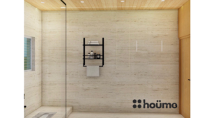 A modern washroom by Houme India with light wood accents, a glass-enclosed shower, a rectangular mirror with an illuminated border, and a white sink. B
