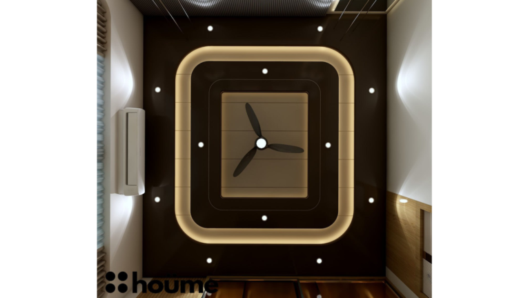 A modern master bedroom by Houme India with a dark recessed ceiling, a gray textured accent wall, and three modern pendant lights hanging above the bed. E
